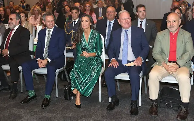 Queen Letizia wore a green scarf print midi dress by Sandro. Carolina Hererea black leather bag. Carolina Herrera pumps