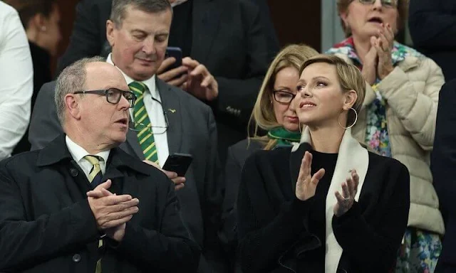 Princess Charlene wore a black wool coat by Akris. Gold hoop earrings. South Africa national rugby union team Springboks