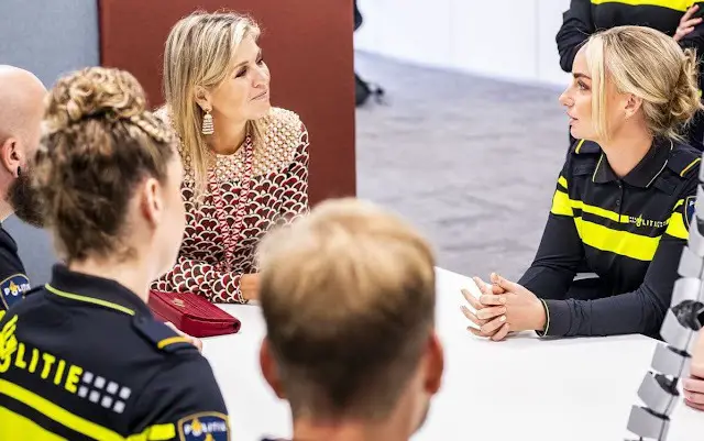 Queen Maxima visited the Roze in Blauw police force. Queen Maxima wore a scale-print silk twill midi dress by Valentino