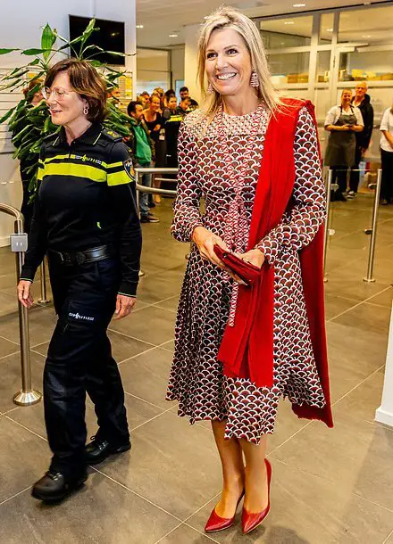 Queen Maxima visited the Roze in Blauw police force. Queen Maxima wore a scale-print silk twill midi dress by Valentino