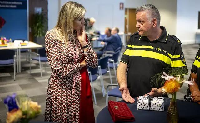 Queen Maxima visited the Roze in Blauw police force. Queen Maxima wore a scale-print silk twill midi dress by Valentino