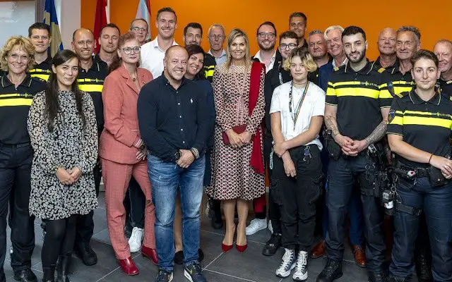 Queen Maxima visited the Roze in Blauw police force. Queen Maxima wore a scale-print silk twill midi dress by Valentino