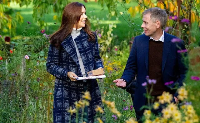 Crown Princess Mary wore a Meghan check wrap coat by Hobbs. White turtleneck cashmere sweater and jeans pants