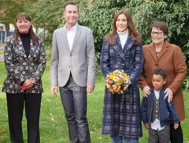 Crown Princess Mary wore a Meghan check wrap coat by Hobbs. White turtleneck cashmere sweater and jeans pants