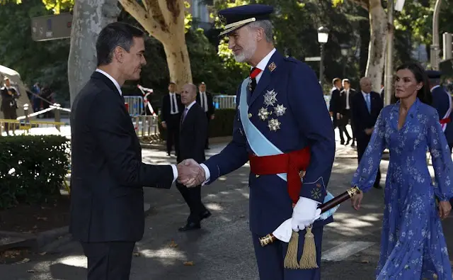 Queen Letizia wore blue printed long sleeve v-neck midi dress by Juan Vidal. Crown Princess Leonor and King Felipe