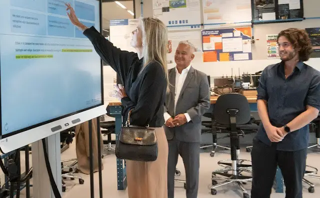 Queen Maxima wore a wool midi skirt by Massimo Dutti. COS draped collar black blouse. Artificial Intelligence Centre