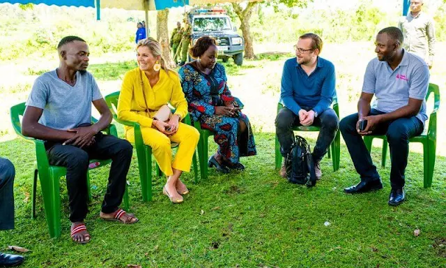 Queen Maxima wore Max Mara yellow poplin shirt and Ginosa yellow pants. Giuseppe Zanotti ballerina flat. Mango Raffia earrings