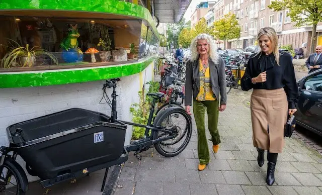 Queen Maxima wore a wool midi skirt by Massimo Dutti. COS draped collar black blouse. FIXbrigade in Amsterdam