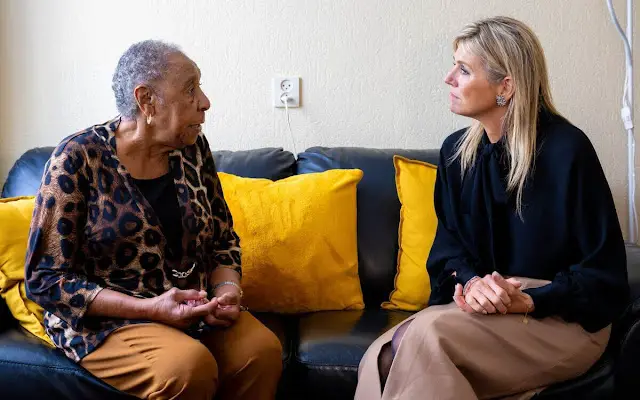 Queen Maxima wore a wool midi skirt by Massimo Dutti. COS draped collar black blouse. FIXbrigade in Amsterdam