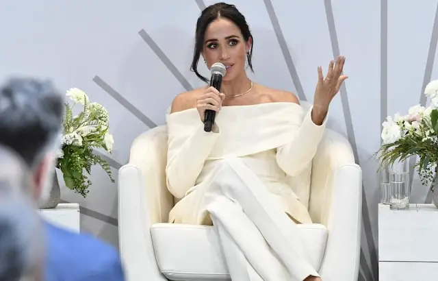 Altuzarra Bendix wide leg-pants. Meghan Markle wore a Wilding off-shoulder virgin wool blazer by Altuzarra