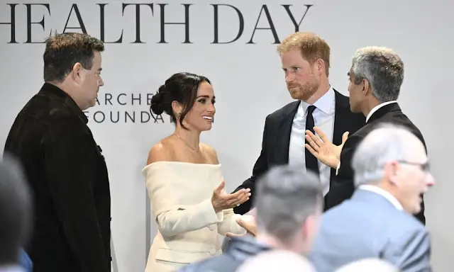 Altuzarra Bendix wide leg-pants. Meghan Markle wore a Wilding off-shoulder virgin wool blazer by Altuzarra