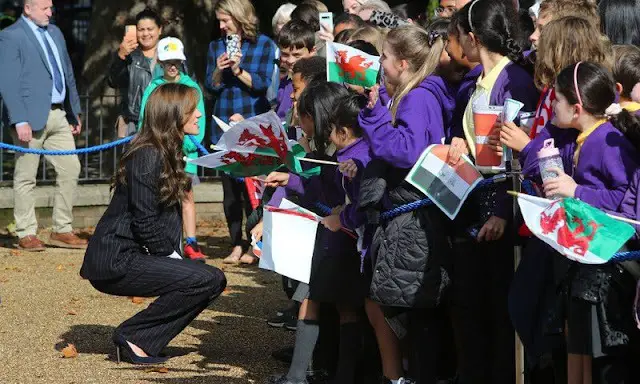 Princess of Wales wore a double-breasted stripe suit and a Cupro shirt bodysuit by Holland Cooper. Shyla earrings