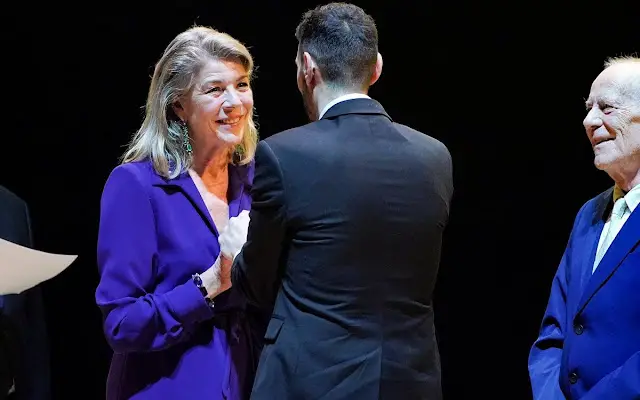 Princess Caroline wore a purple belted crepe maxi dress by Dries van Noten. Charlotte Casiraghi wore a pink top and pants