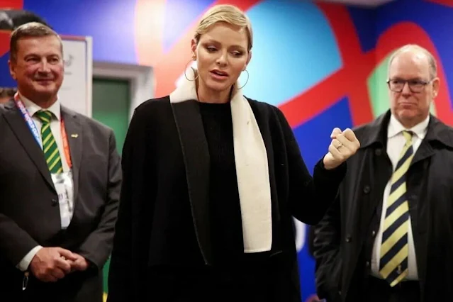 Princess Charlene wore a black wool coat by Akris. Gold hoop earrings. South Africa national rugby union team Springboks