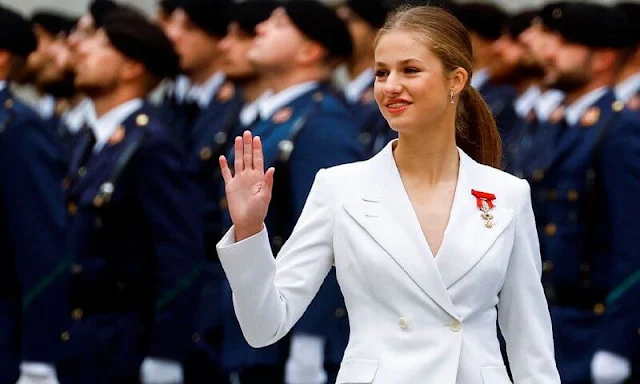 Princess Leonor wore a white suit by Sastreria Serna. Queen Letizia in Carolina Herrera. Infanta Sofia wore a Verdie dress by Erdem