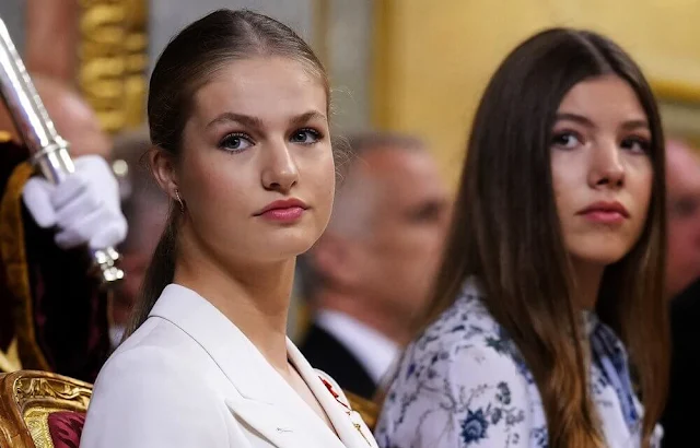 Princess Leonor wore a white suit by Sastreria Serna. Queen Letizia in Carolina Herrera. Infanta Sofia wore a Verdie dress by Erdem