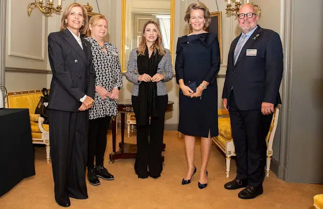 Queen Mathilde wore a new navy blue Structured scuba midi dress by Natan. European Commissioner Stella Kyriakides