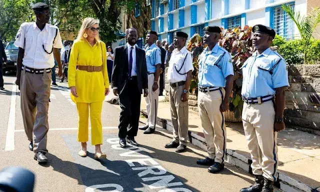 Queen Maxima wore Max Mara yellow poplin shirt and Ginosa yellow pants. Giuseppe Zanotti ballerina flat. Mango Raffia earrings