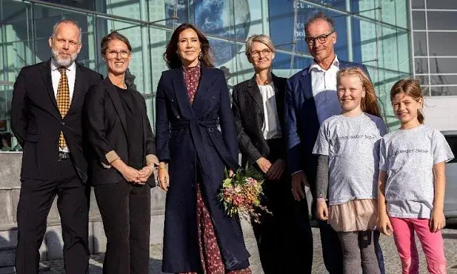 Crown Princess Mary wore a wine red Jacqui B dress by Saloni with navy blue wool coat. Novo Nordisk Foundation