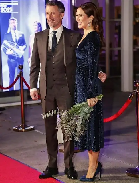 Crown Princess Mary is wearing a Rotate Birger Christensen velvet glitter midi dress. Gianvito Rossi pumps and Prada clutch