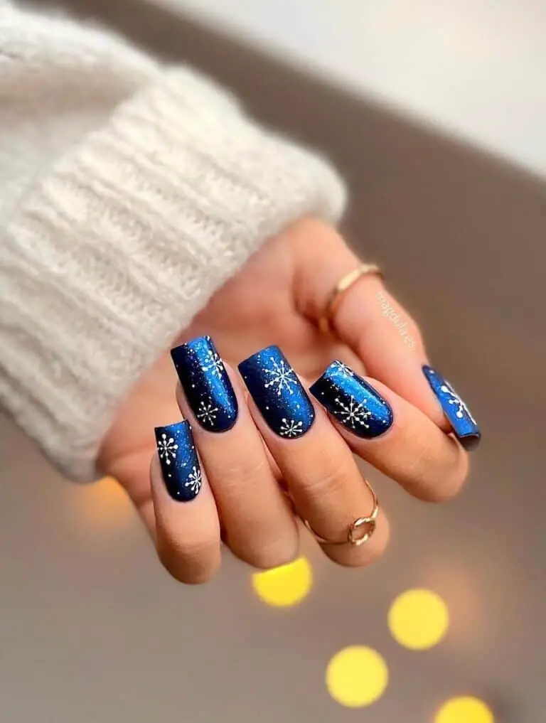 Blue Nails with White Snowflake Designs