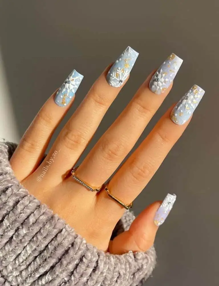 Light Blue Nails adorned with Charming Snowflakes and Gold Flakes