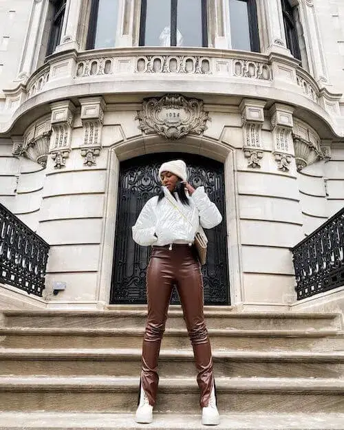 Cool and Casual: White Cropped Puffer Jacket, Beanie, and Faux Leather Pants