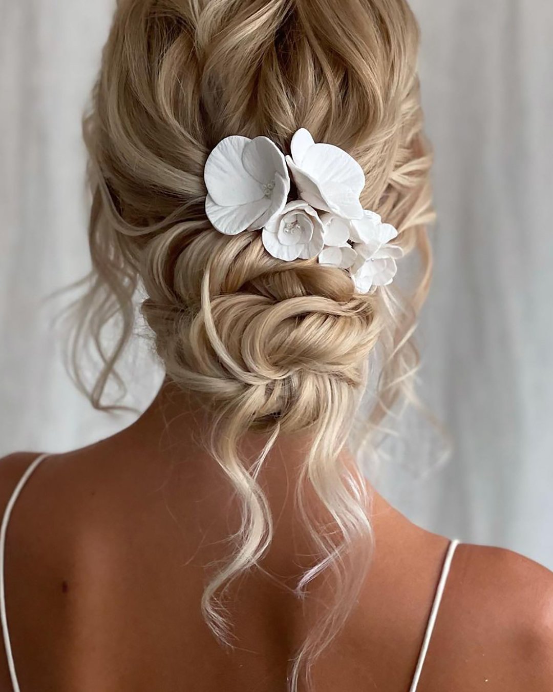 boho wedding hairstyles elegant low bun with loose curls and flower pins kasia_fortuna