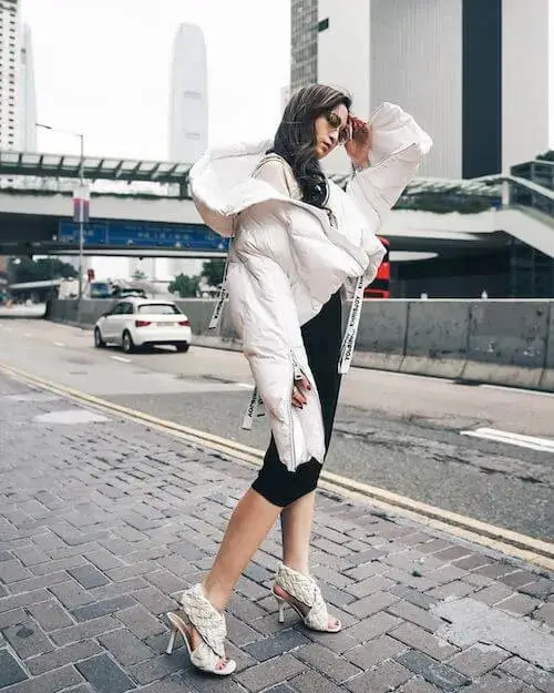 Sophisticated Street Style: White Puffer Jacket Paired with a Dress