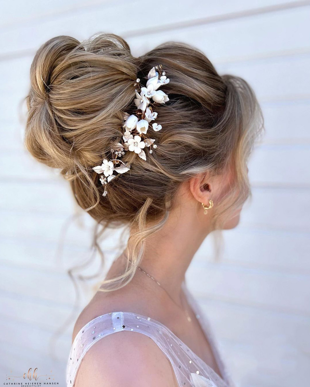 boho wedding hairstyles high bun with flower pin cathrineheierenhansen