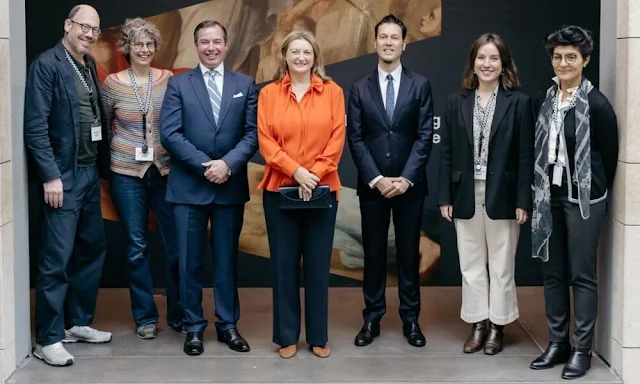 Princess Stephanie wore an orange silk blouse by Paule Ka. Belgian-Luxembourgish art historian Henri Careme