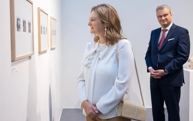 Princess Stephanie wore a white silk blouse by Paule Ka. Beige camel wide leg pants. Grand Duke Henri of Luxembourg