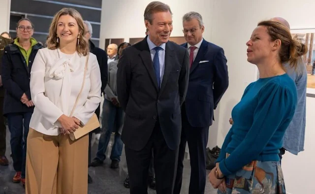 Princess Stephanie wore a white silk blouse by Paule Ka. Beige camel wide leg pants. Grand Duke Henri of Luxembourg