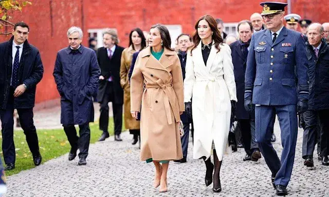 Queen Letizia wore a green midi dress by Dandara, and Carolina herrera coat. Princess Mary wore a Red Valentino top