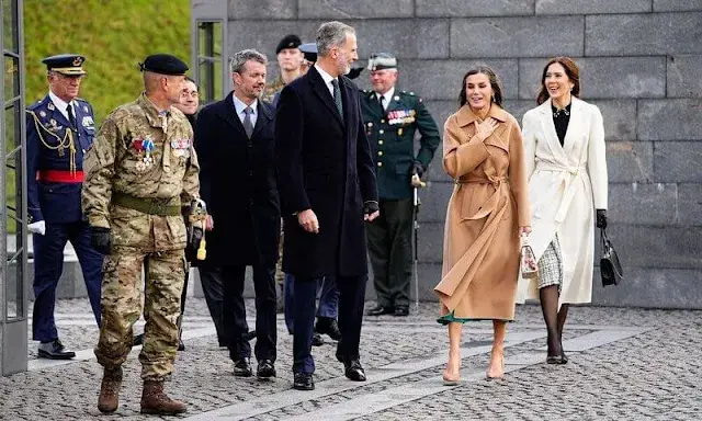 Queen Letizia wore a green midi dress by Dandara, and Carolina herrera coat. Princess Mary wore a Red Valentino top