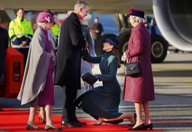 Queen Letizia wore long belted wool coat by & Other Stories. Crown Princess Mary wore a green coat by The Fold