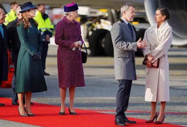 Queen Letizia wore long belted wool coat by & Other Stories. Crown Princess Mary wore a green coat by The Fold