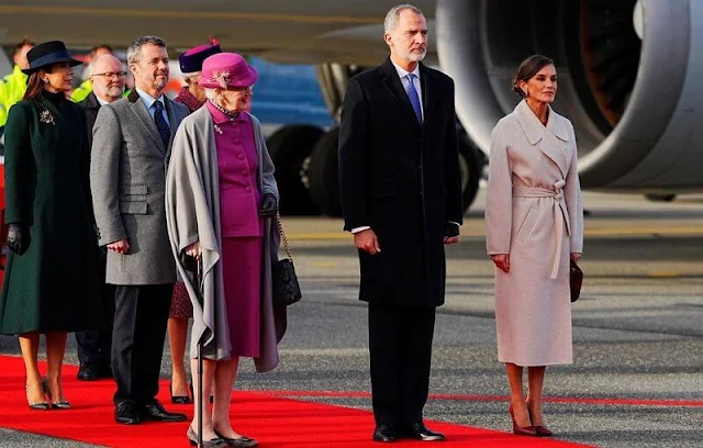 Queen Letizia wore long belted wool coat by & Other Stories. Crown Princess Mary wore a green coat by The Fold