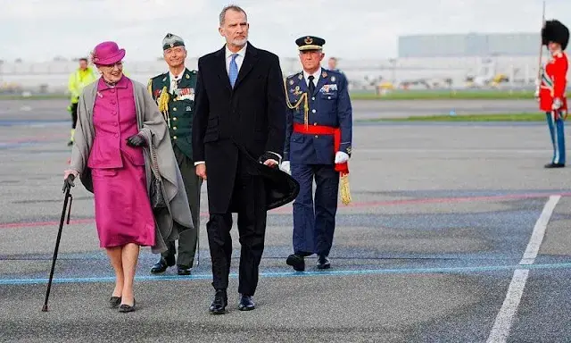 Queen Letizia wore long belted wool coat by & Other Stories. Crown Princess Mary wore a green coat by The Fold