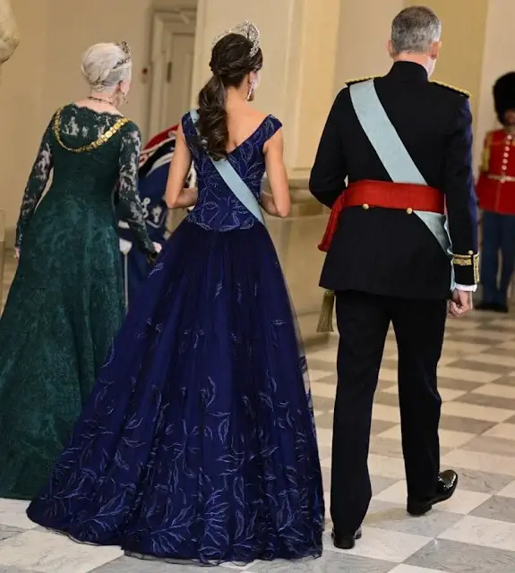 Queen Letizia wearing Felipe Varela navy gown. Crown Princess Mary wearing Lasse Spangenberg gown