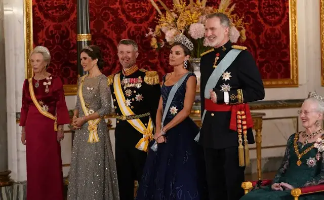 Queen Letizia wearing Felipe Varela navy gown. Crown Princess Mary wearing Lasse Spangenberg gown