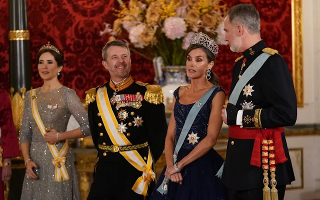 Queen Letizia wearing Felipe Varela navy gown. Crown Princess Mary wearing Lasse Spangenberg gown