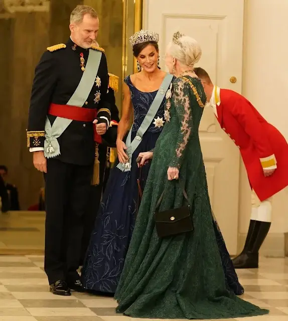 Queen Letizia wearing Felipe Varela navy gown. Crown Princess Mary wearing Lasse Spangenberg gown