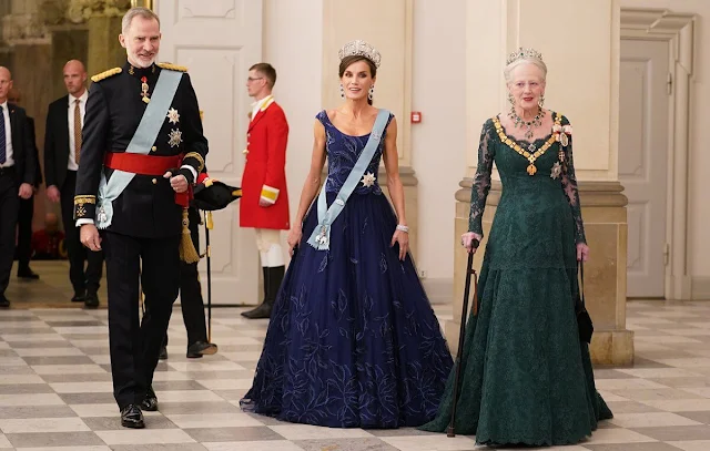 Queen Letizia wearing Felipe Varela navy gown. Crown Princess Mary wearing Lasse Spangenberg gown