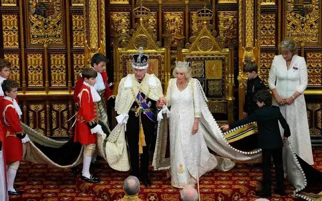 King Charles wearing the Imperial State Crown and the Robe of State, Queen Camilla, wearing the George IV State Diadem