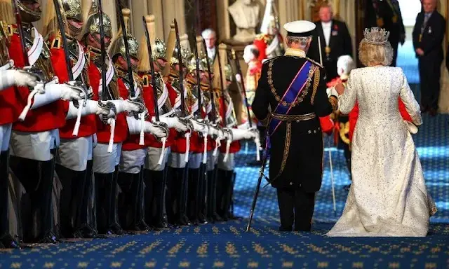 King Charles wearing the Imperial State Crown and the Robe of State, Queen Camilla, wearing the George IV State Diadem