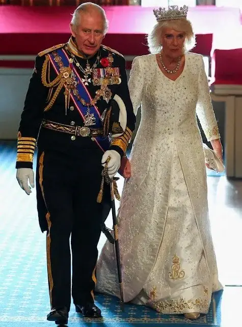 King Charles wearing the Imperial State Crown and the Robe of State, Queen Camilla, wearing the George IV State Diadem