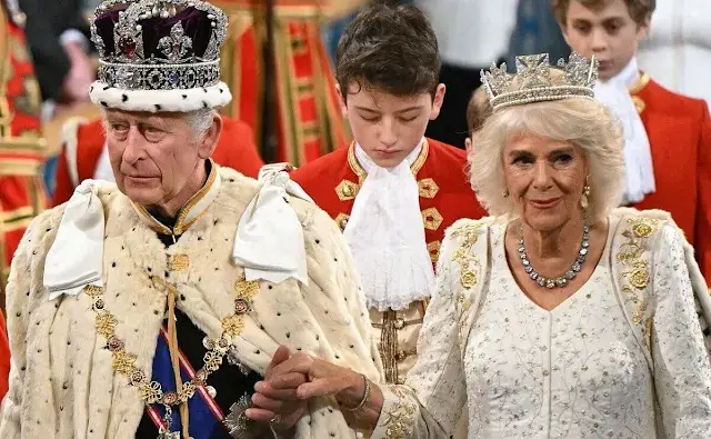 King Charles wearing the Imperial State Crown and the Robe of State, Queen Camilla, wearing the George IV State Diadem