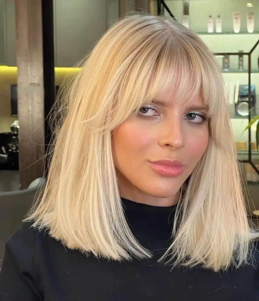 Medium-Length Hairstyles with Bangs: Shine Bright with a Shoulder-Length Blonde Bob