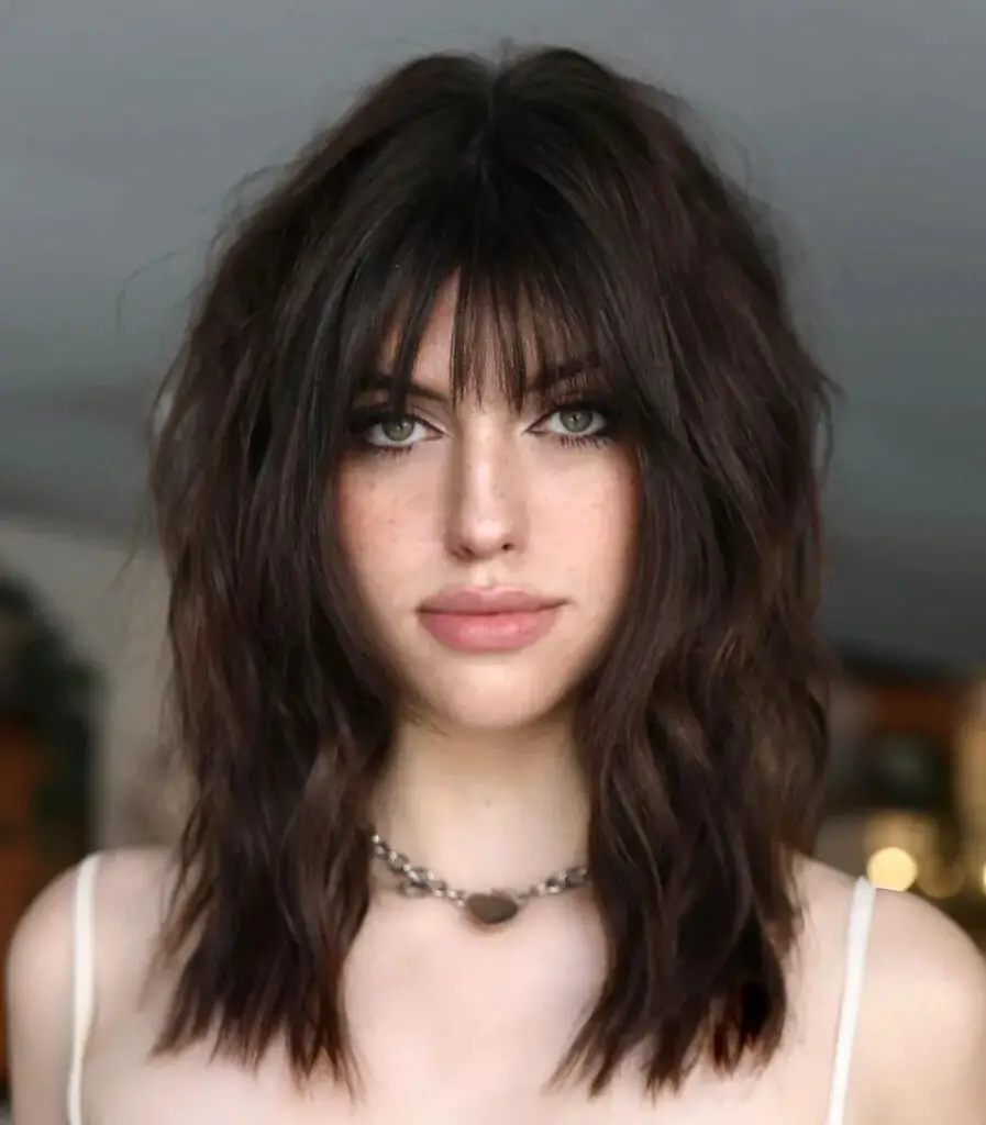 Medium-Length Hairstyles with Bangs: Achieve Elegance with a Medium Layered Haircut and Wispy Bangs